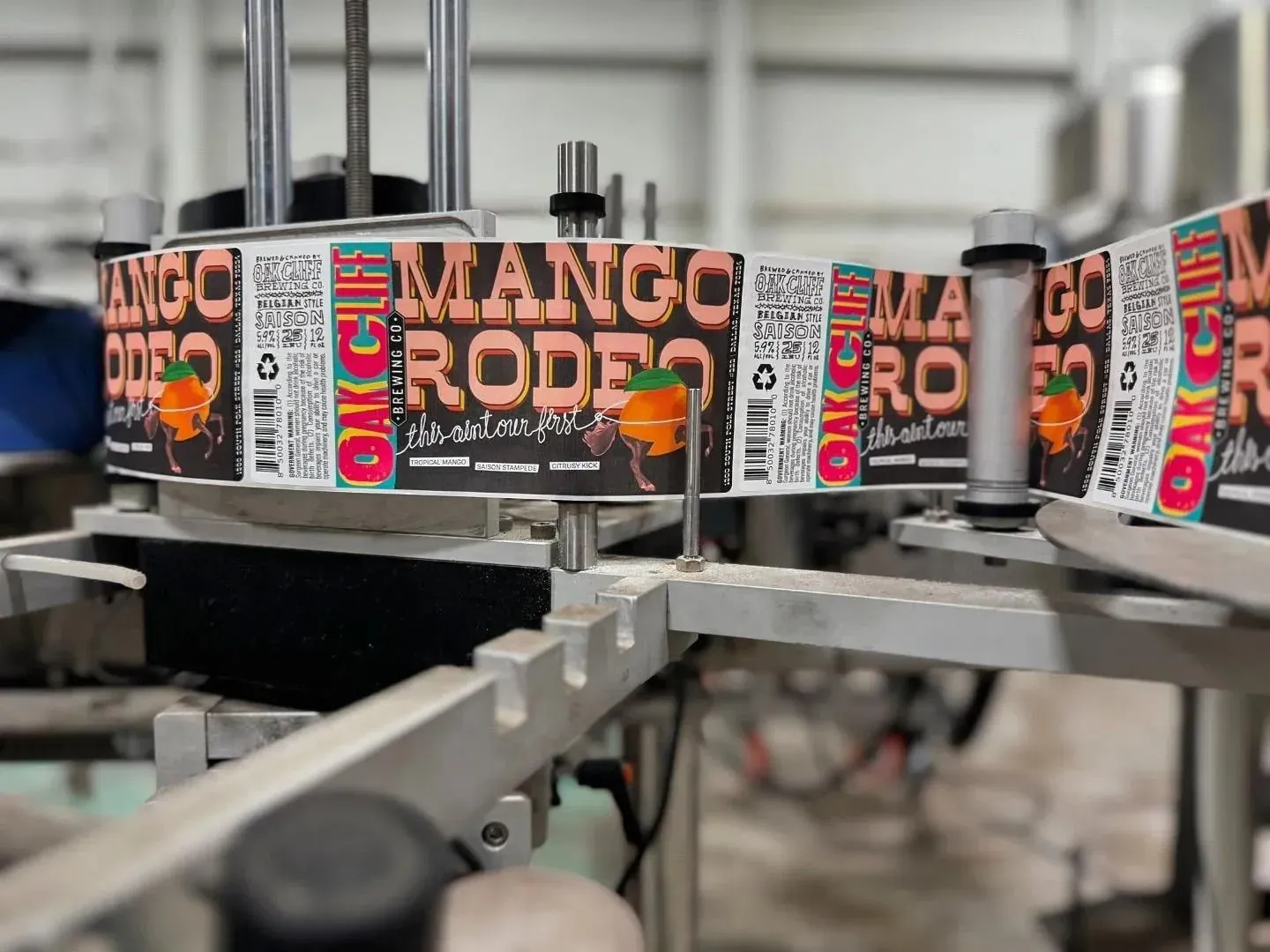 Printed product labels running through a labeling machine on a factory production line